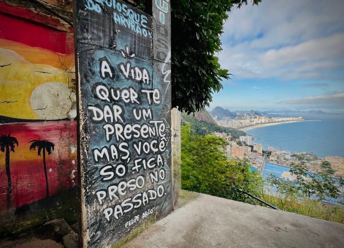 Poesia dipinta su un muro del Vidigal, con il mare sullo sfondo
